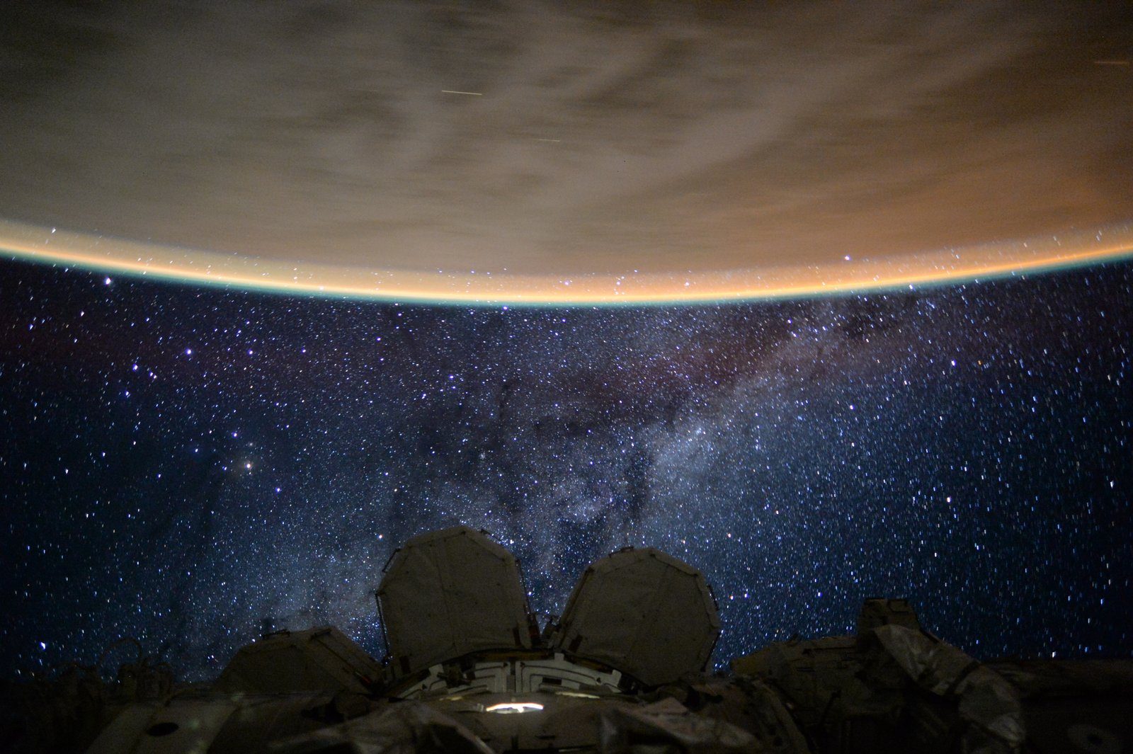 The Perseid meteor shower photographed from the International Space Station, showing a meteor streak burning up in Earth's atmosphere