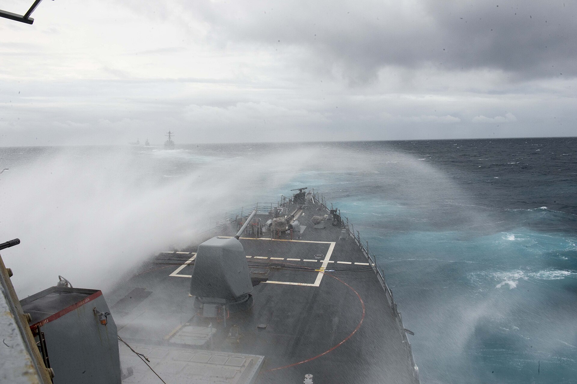 Waves crash over the bow of the guided-missile destroyer USS Arleigh Burke in the Atlantic Ocean